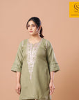 Olive kurta set with hand mirror work and lace-trimmed bell sleeves